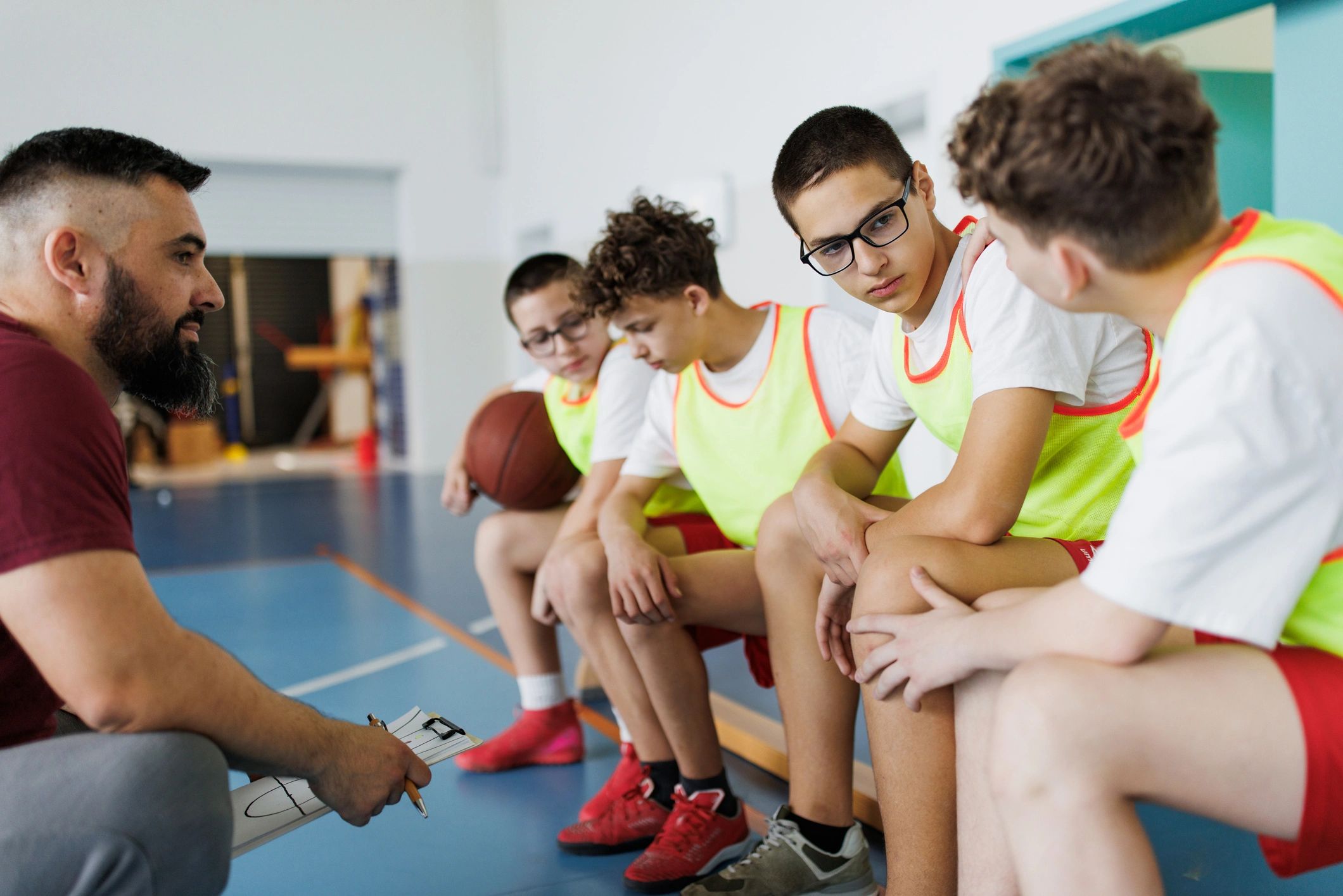 Coach talking with players during practice